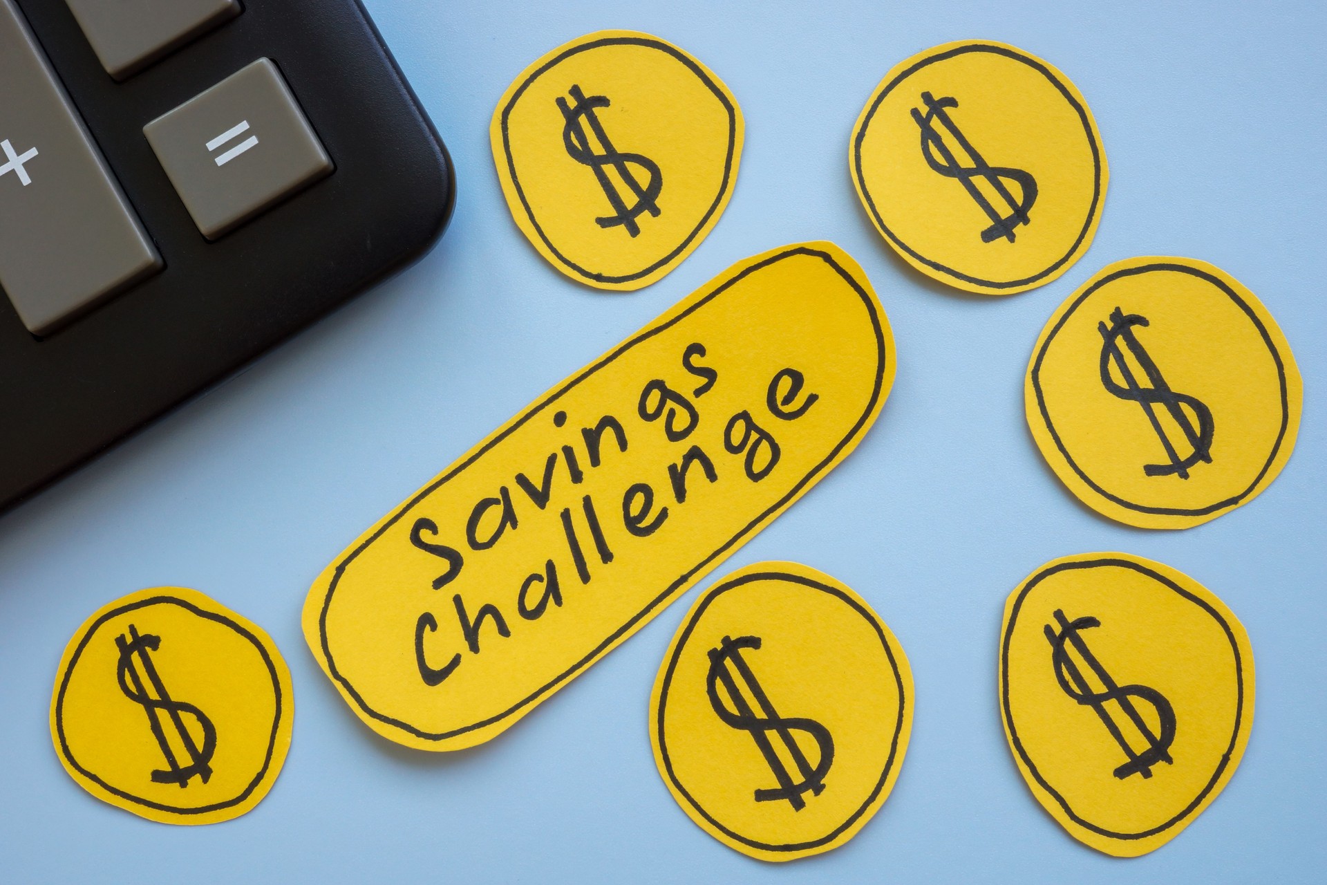 The label savings challenge with dollar signs and a calculator. Financial goals and money management.